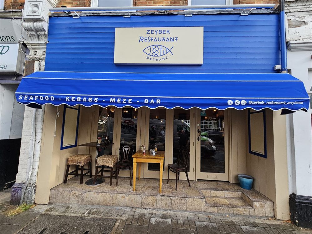 Blue restaurant awning and shopfront signage