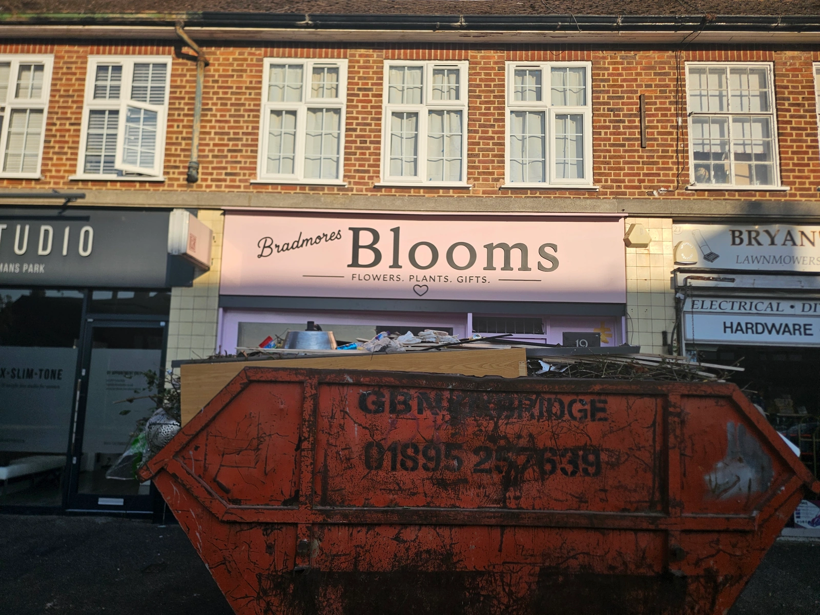 Bradmores Blooms pink florist fascia with black lettering for flowers, plants and gifts