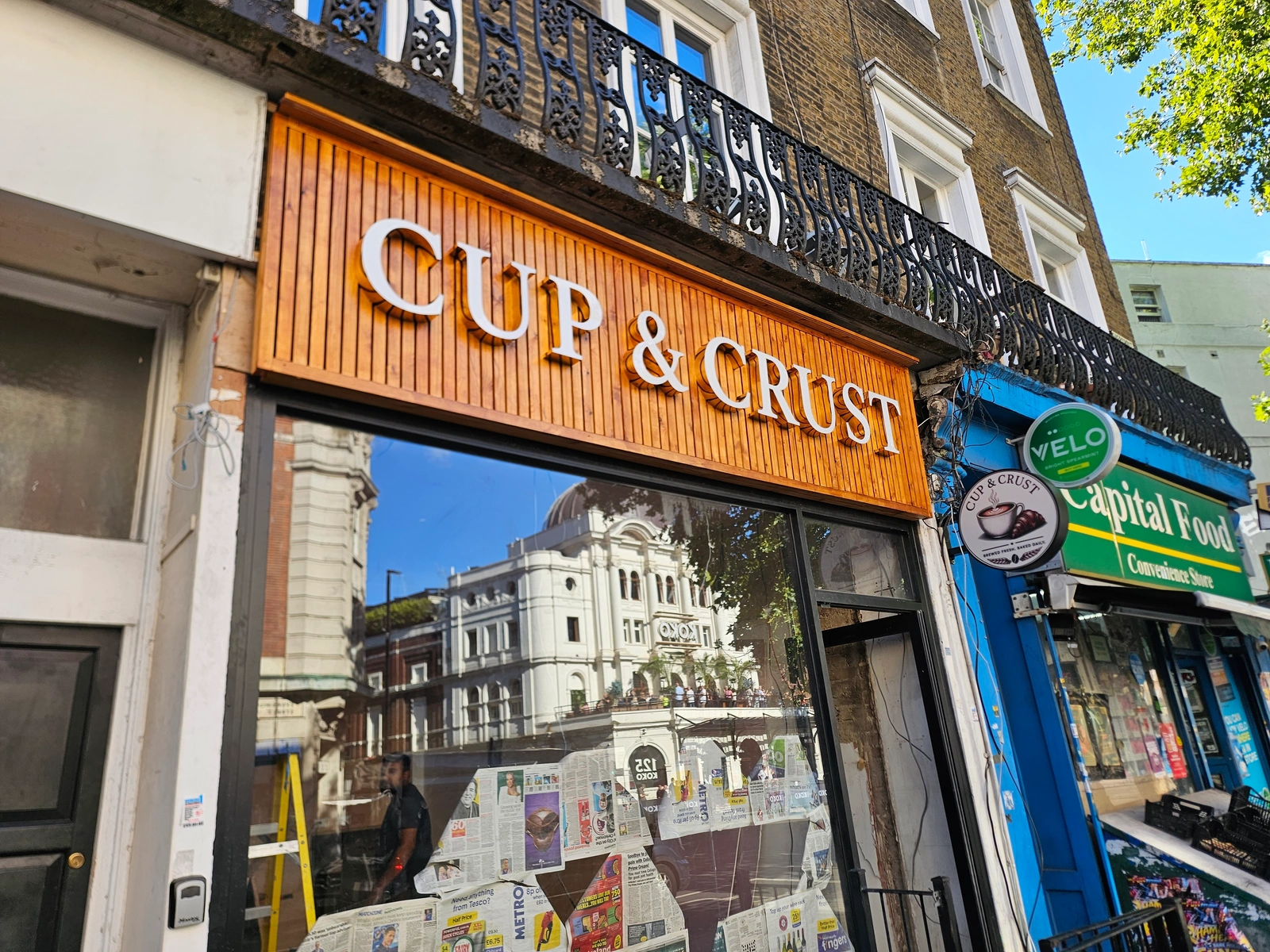 Cup & Crust white raised shopfront letters on a timber fascia with a matching round projecting sign