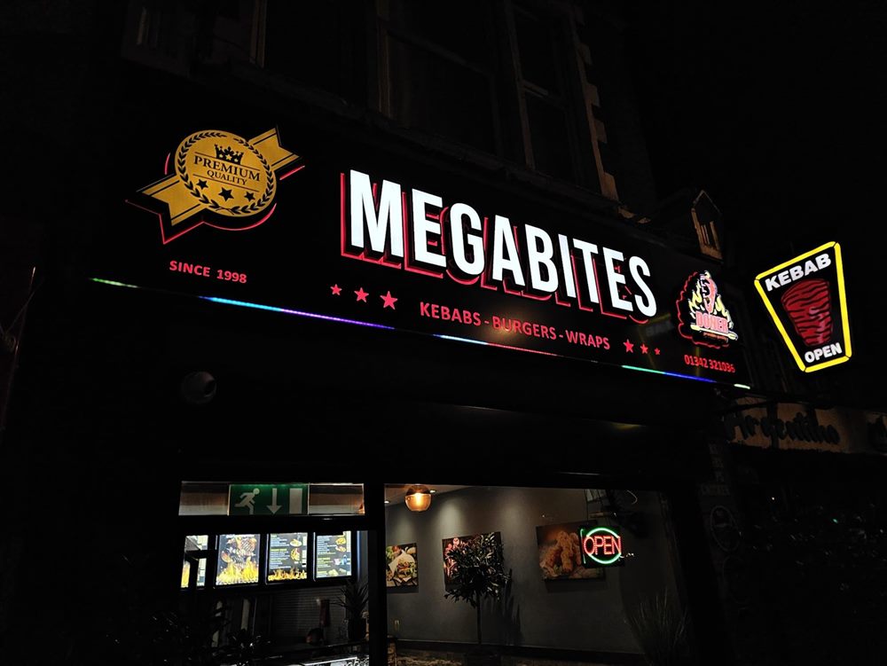 Illuminated restaurant shopfront and window menu