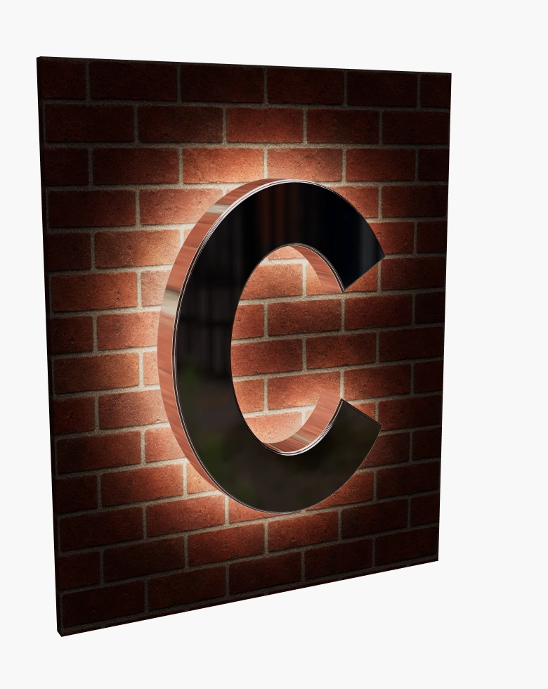 Metal C sign with warm halo lighting at night