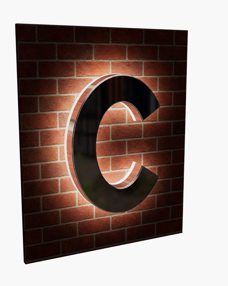 Metal C sign with an illuminated acrylic back at night